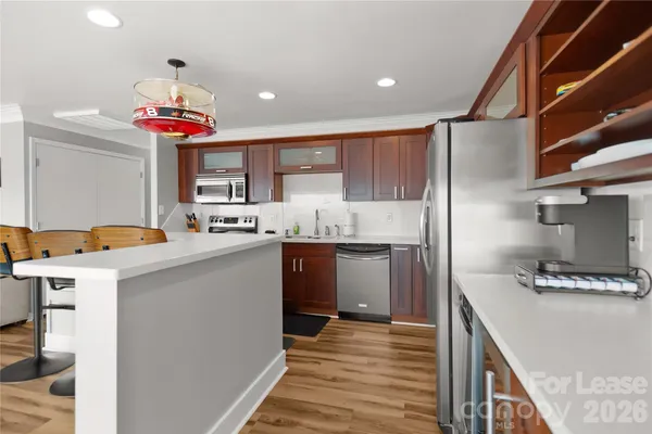 a kitchen with stainless steel appliances granite countertop a sink stove and cabinets