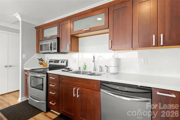 a kitchen with stainless steel appliances granite countertop a refrigerator and a sink