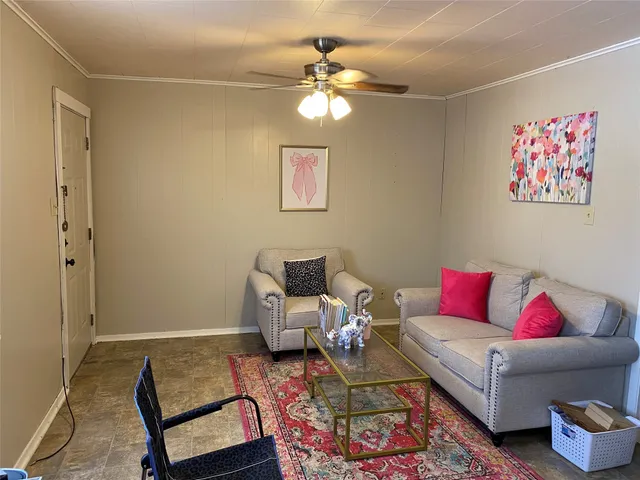 a living room with furniture and a rug