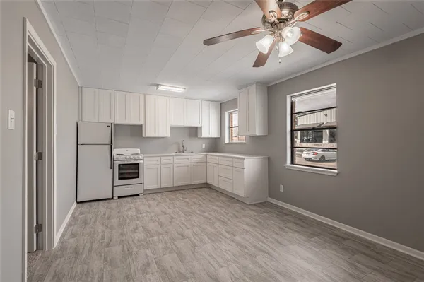 a kitchen with stainless steel appliances a refrigerator sink and cabinets