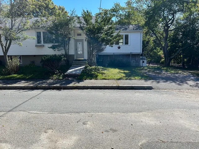 a front view of a house with a yard and a garage