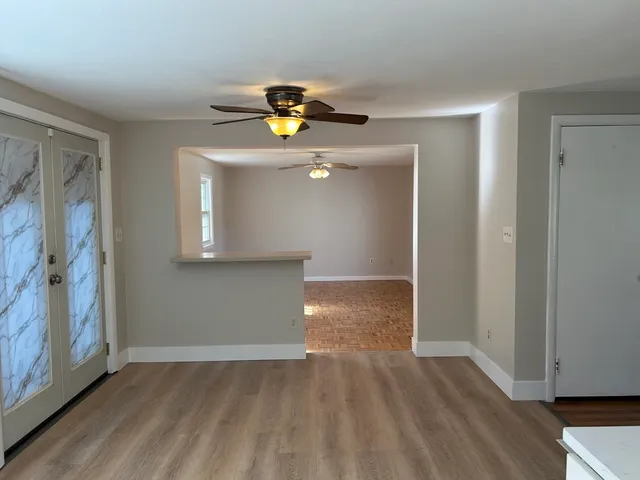 a view of an entryway with wooden floor