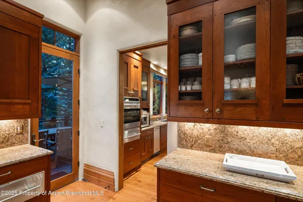 a kitchen with a refrigerator and a stove