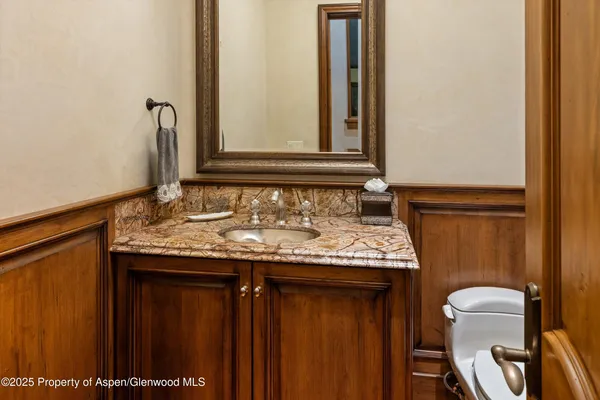 a spacious bathroom with sinks granite countertop tub and a mirror