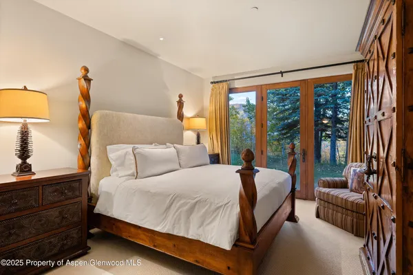 a bedroom with a bed and a large window