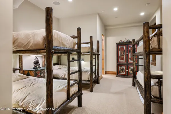a living room with furniture a chandelier and a piano