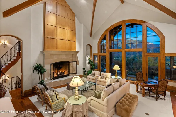 a living room with furniture a fireplace and a potted plant