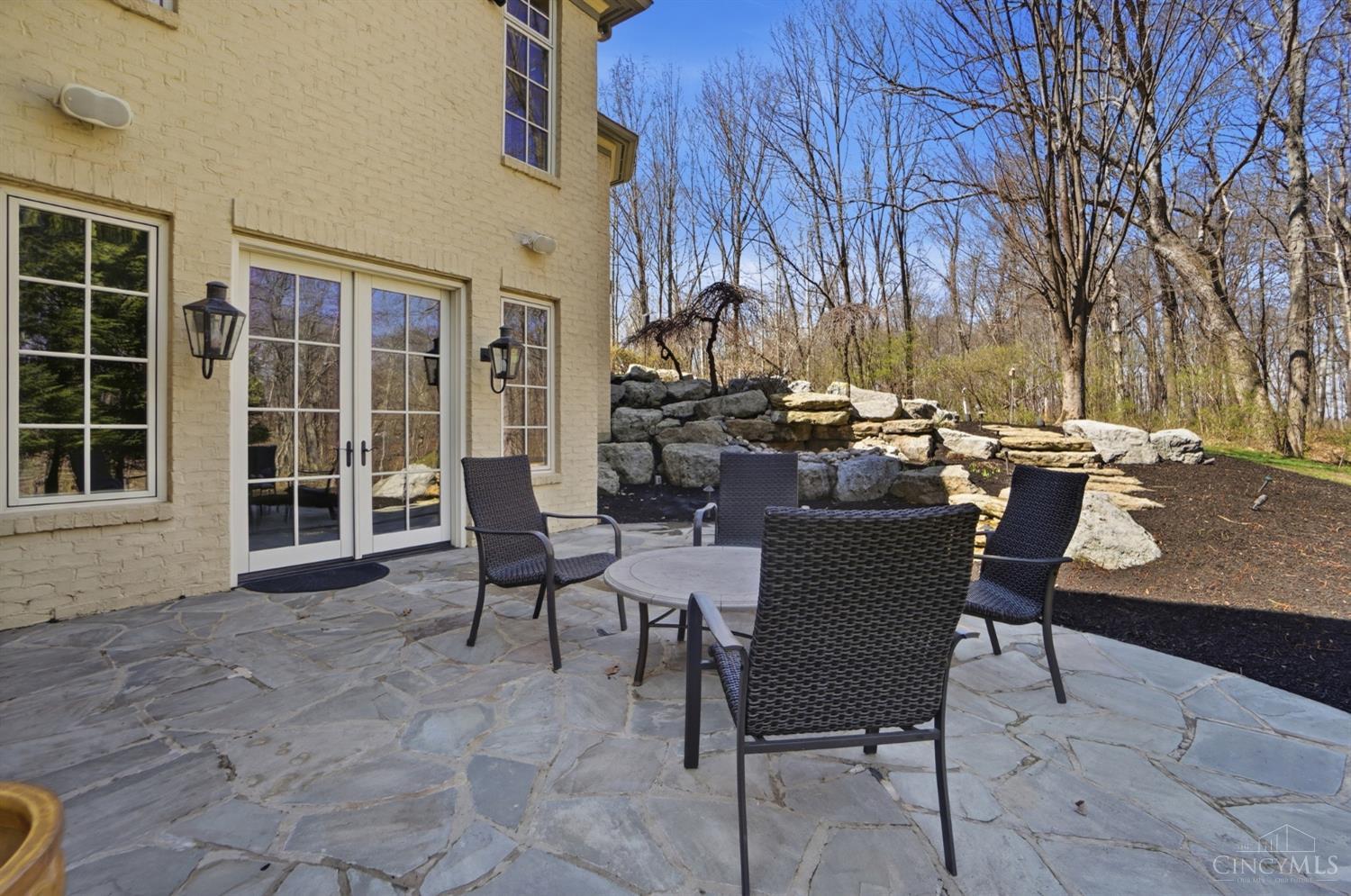 1054 Observatory Point Maineville, OH 45039 - Photo 71 of 82 Patio setting off the owner's suite. Wait until those trees have filled in. View the waterfall just beyond the patio.