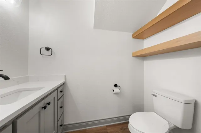 a view of a room with wooden floor