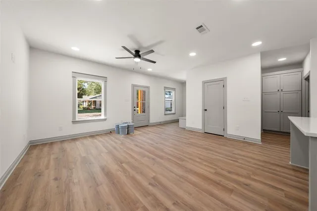 a bathroom with a granite countertop toilet and a sink