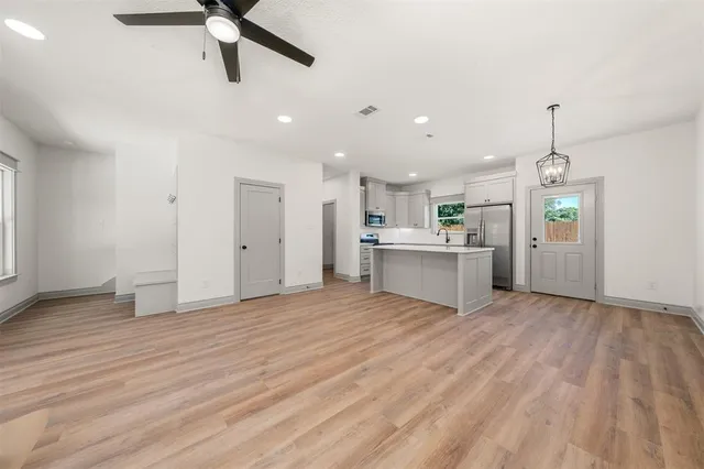 a front view of a house with a yard and trees