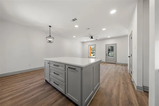 a kitchen with stove cabinets and wooden floor