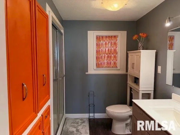 a bathroom with a toilet sink and shower