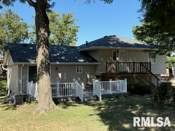 a view of house with yard and outdoor seating