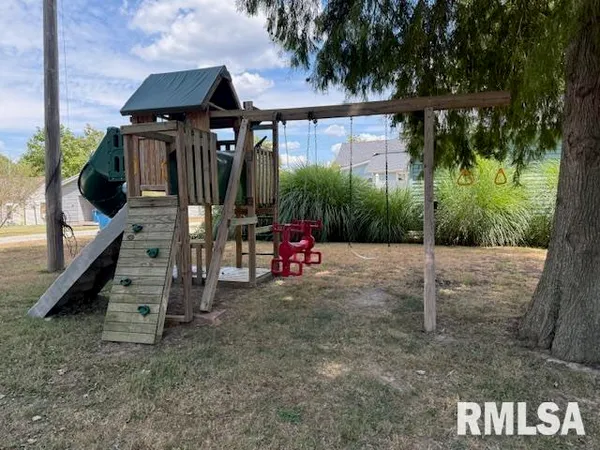a backyard of a house with barbeque oven table and chairs