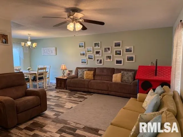 a living room with furniture ceiling fan and a rug