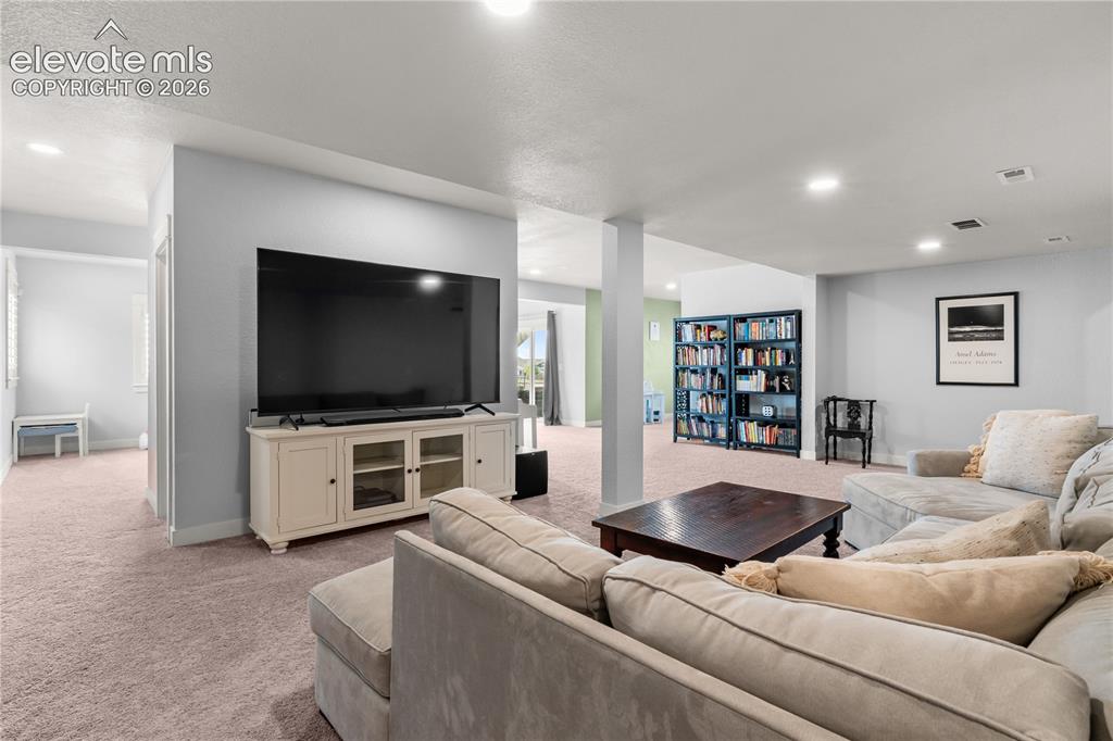 12781 Granite Ridge Drive Peyton, CO 80831 - Photo 25 of 41 The basement is truly a retreat. The walkout fills it with natural light and it is expansive for so many different hobbies or relaxation.