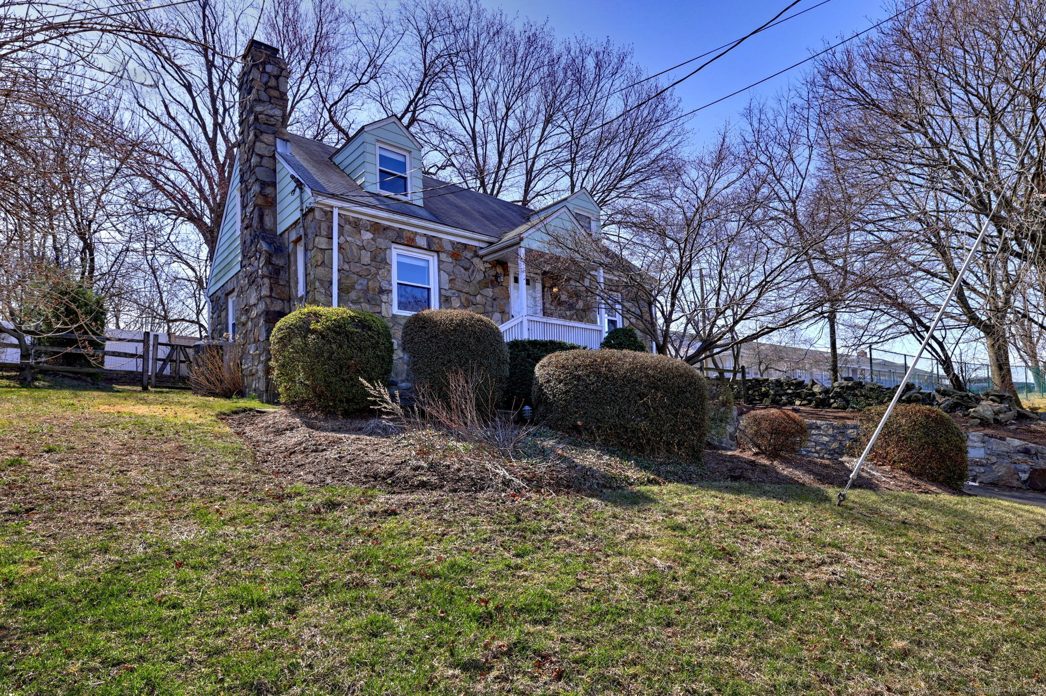 a front view of house with yard and trees