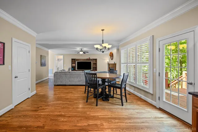 a kitchen with stainless steel appliances granite countertop wooden cabinets a stove top oven a sink and dishwasher with wooden floor