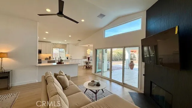 a room with lots of chairs and view of kitchen