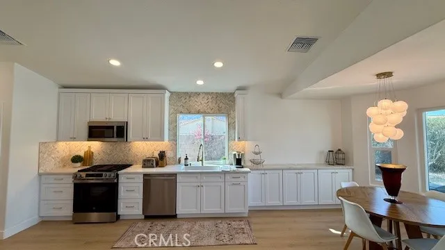a kitchen with a refrigerator and a stove top oven