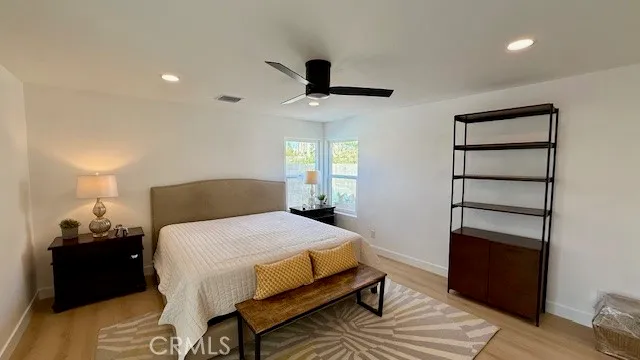 a bedroom with a bed and wooden floor