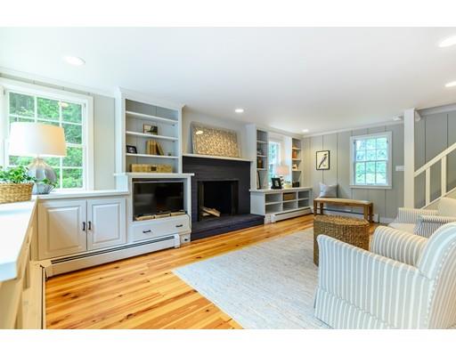 234 Highland Road Andover, MA 01810 - Photo 9 of 29 a living room with furniture a fireplace and a flat screen tv