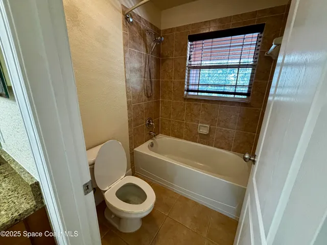 a bathroom with a toilet and a bathtub