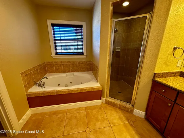 a bathroom with a tub and a shower