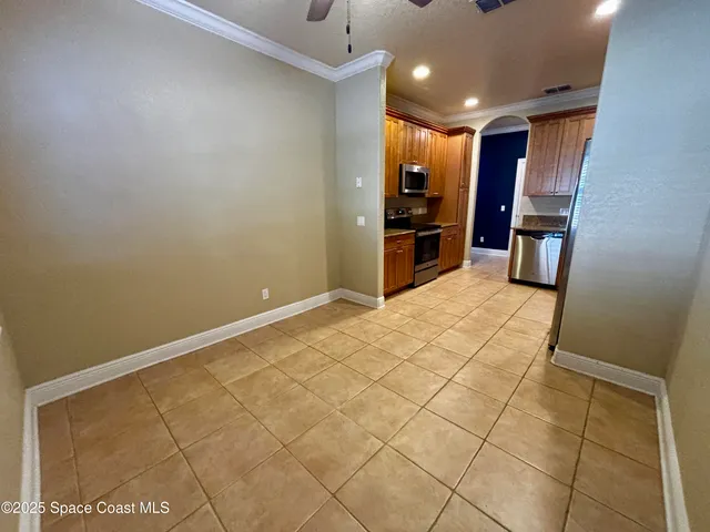 a kitchen with stainless steel appliances a refrigerator and microwave