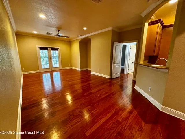 a view of a hallway with wooden floor