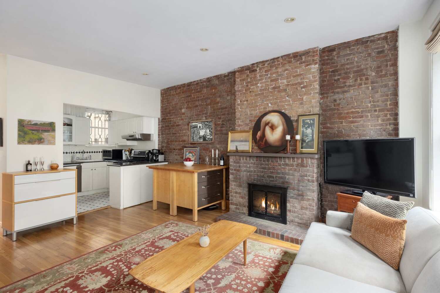 204 West 92nd Street, Unit 2F Manhattan, NY 10025 - Photo 3 of 10 a living room with furniture a flat screen tv and a fireplace