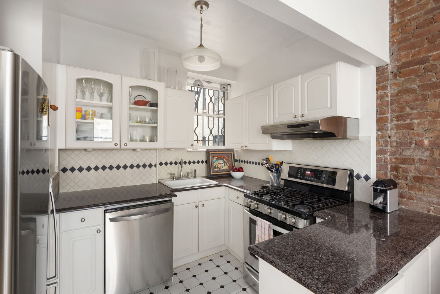 204 West 92nd Street, Unit 2F Manhattan, NY 10025 - Photo 4 of 10 a kitchen with stainless steel appliances a stove a sink and a refrigerator