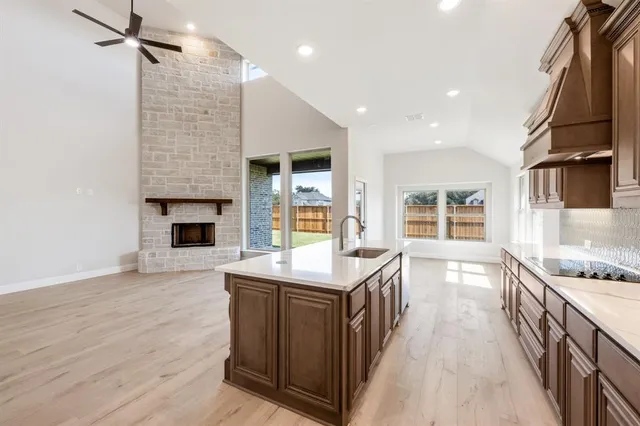 a kitchen with kitchen island a sink stove and oven