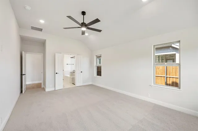 a view of empty room with wooden floor and window