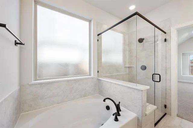 a bathroom with a tub and shower