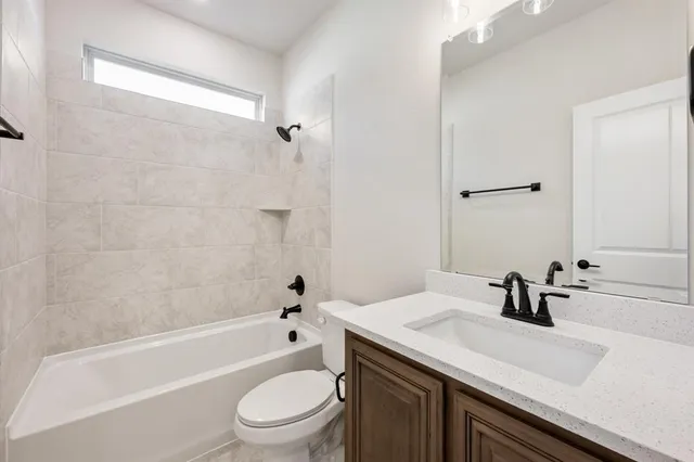 a bathroom with a sink a toilet and a bathtub