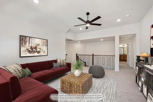 a living room with furniture and a ceiling fan