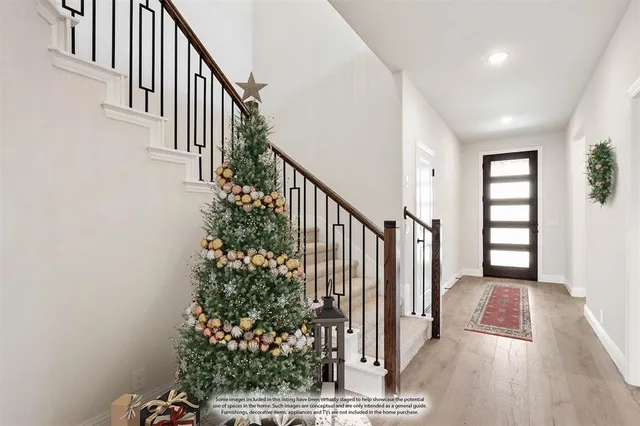 a view of entryway with wooden floor and stairs