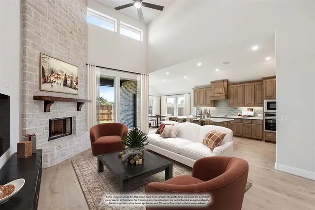 a living room with furniture fireplace and kitchen view