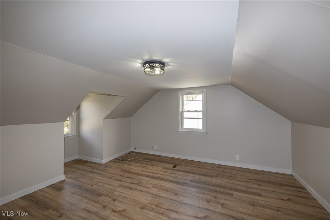 16002 Turney Road Maple Heights, OH 44137 - Photo 23 of 29 Bonus room with healthy amount of natural light, light wood-style flooring, and vaulted ceiling