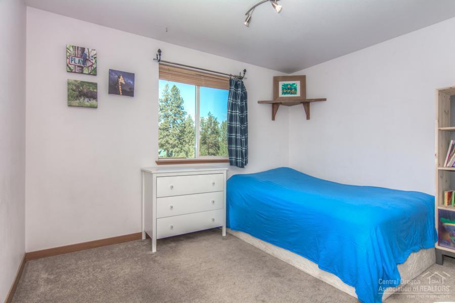 19548 Apache Road Bend, OR 97702 - Photo 16 of 25 a bedroom with a bed and a window