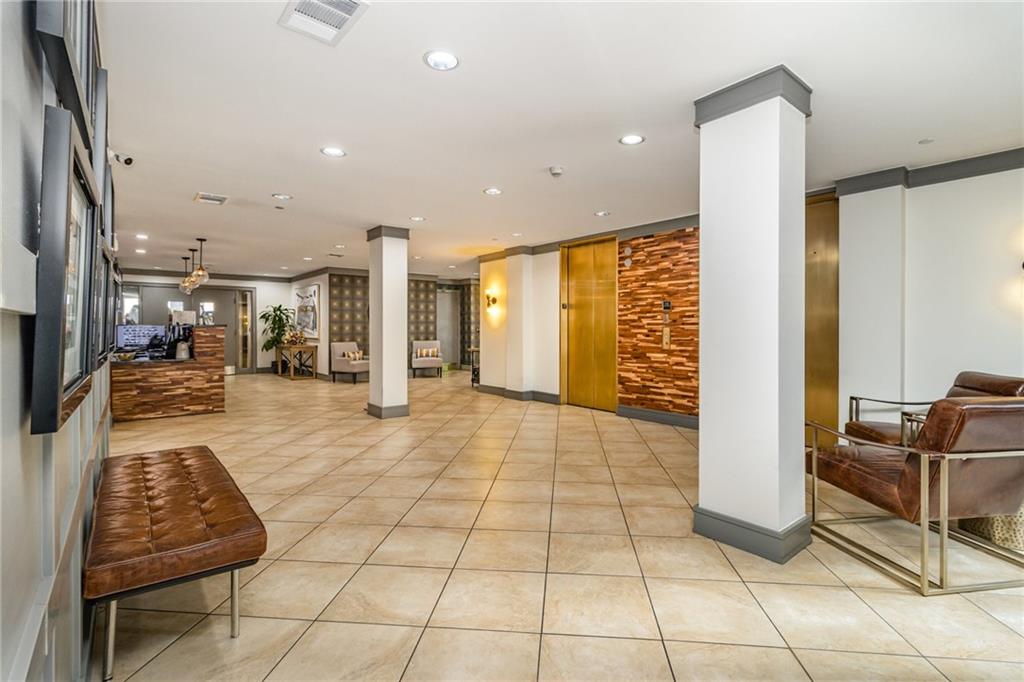 1101 Juniper Street Northeast, Unit 822 Atlanta, GA 30309 - Photo 19 of 37 a lobby with furniture and rug