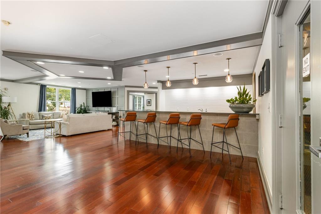 1101 Juniper Street Northeast, Unit 822 Atlanta, GA 30309 - Photo 20 of 37 a living room with furniture and kitchen view