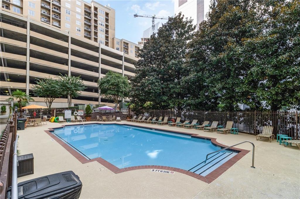 1101 Juniper Street Northeast, Unit 822 Atlanta, GA 30309 - Photo 32 of 37 a view of a swimming pool with a patio