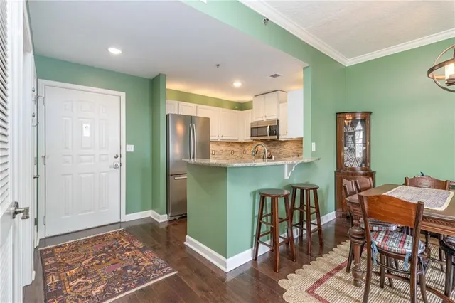 a open kitchen with stainless steel appliances granite countertop a refrigerator and microwave