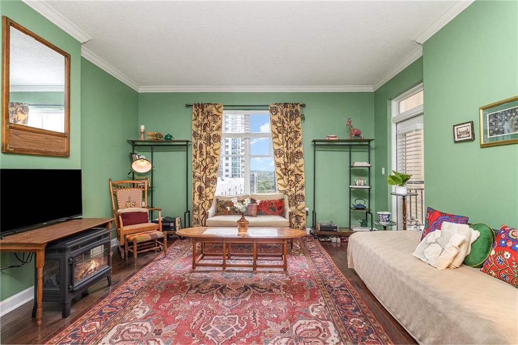 1101 Juniper Street Northeast, Unit 822 Atlanta, GA 30309 - Photo 7 of 37 a living room with furniture and a flat screen tv