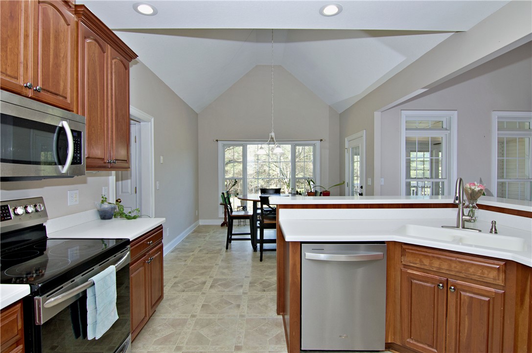 7893 Athens Road Carnesville, GA 30521 - Photo 14 of 50 This bright kitchen features vaulted ceilings and modern appliances, perfect for everyday living.