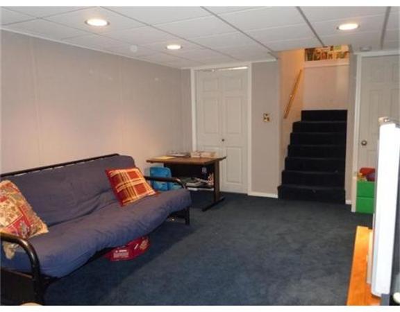 325 Mammoth Road, Unit 4 Lowell, MA 01854 - Photo 28 of 29 a living room with furniture and stairs