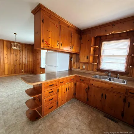 a large kitchen with stainless steel appliances granite countertop a sink and a dishwasher next to a window